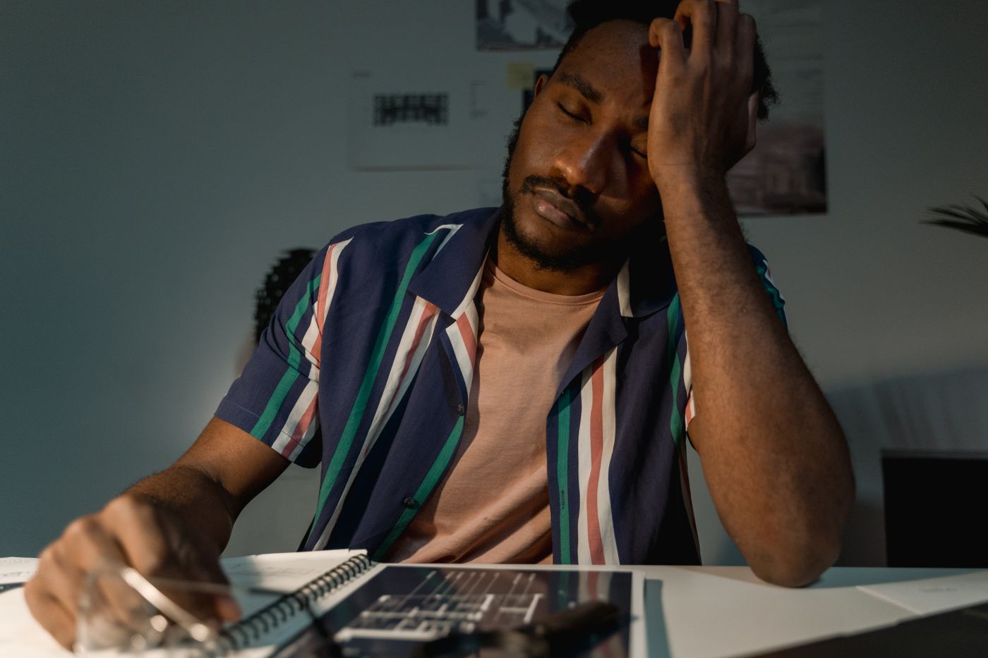 A man sitting at his desk late, worn out